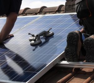 Solar panel being installed on a roof