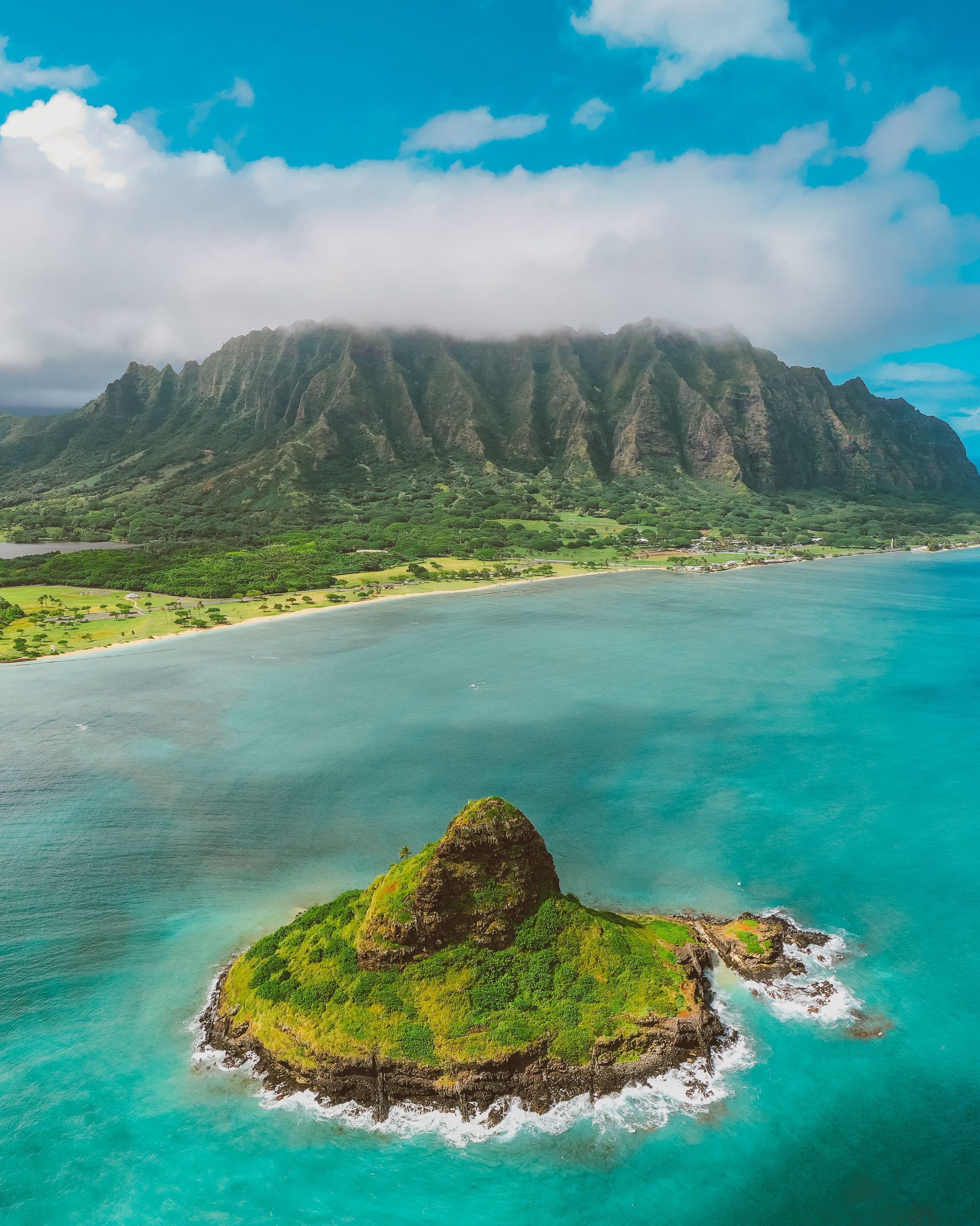 Stunning aerial shot of Mokoli'i Island and lush mountains, perfect for nature lovers.